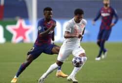 Barcelona's Nelson Semedo, left, challenges Bayern's Serge Gnabry, right, during the Champions League quarterfinal match between FC Barcelona and Bayern Munich at the Luz stadium in Lisbon, Portugal, Friday, Aug. 14, 2020. (AP Photo/Manu Fernandez/Pool)  PJO121