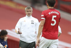 Manchester United's manager Ole Gunnar Solskjaer talks to Manchester United's Harry Maguire during the English Premier League soccer match between Manchester United and West Ham at the Old Trafford stadium in Manchester, England, Wednesday, July 22, 2020. (Martin Rickett/Pool via AP)  XDB198