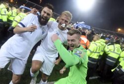Finnish captain Tim Sparv, left, celebrates with Paulus Arajuuri, center, and goalkeeper Lukas Hradecky after their victory in the Euro 2020 Group J qualifying soccer match between Finland and Liechtenstein in Helsinki, Finland, on Friday, Nov. 15, 2019. Finland won 3-0 and have qualified for a major soccer tournament for the first time in their history. (Markku Ulander/Lehtikuva via AP)  LLTT820