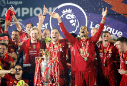 FILE PHOTO: Soccer Football - Premier League - Liverpool v Chelsea - Anfield, Liverpool, Britain - July 22, 2020 Liverpool's Jordan Henderson with teammates celebrates with the trophy after winning the Premier League Pool via REUTERS/Phil Noble EDITORIAL USE ONLY. No use with unauthorized audio, video, data, fixture lists, club/league logos or 'live' services. Online in-match use limited to 75 images, no video emulation. No use in betting, games or single club/league/player publications.  Please contact your account representative for further details./File Photo  X01988