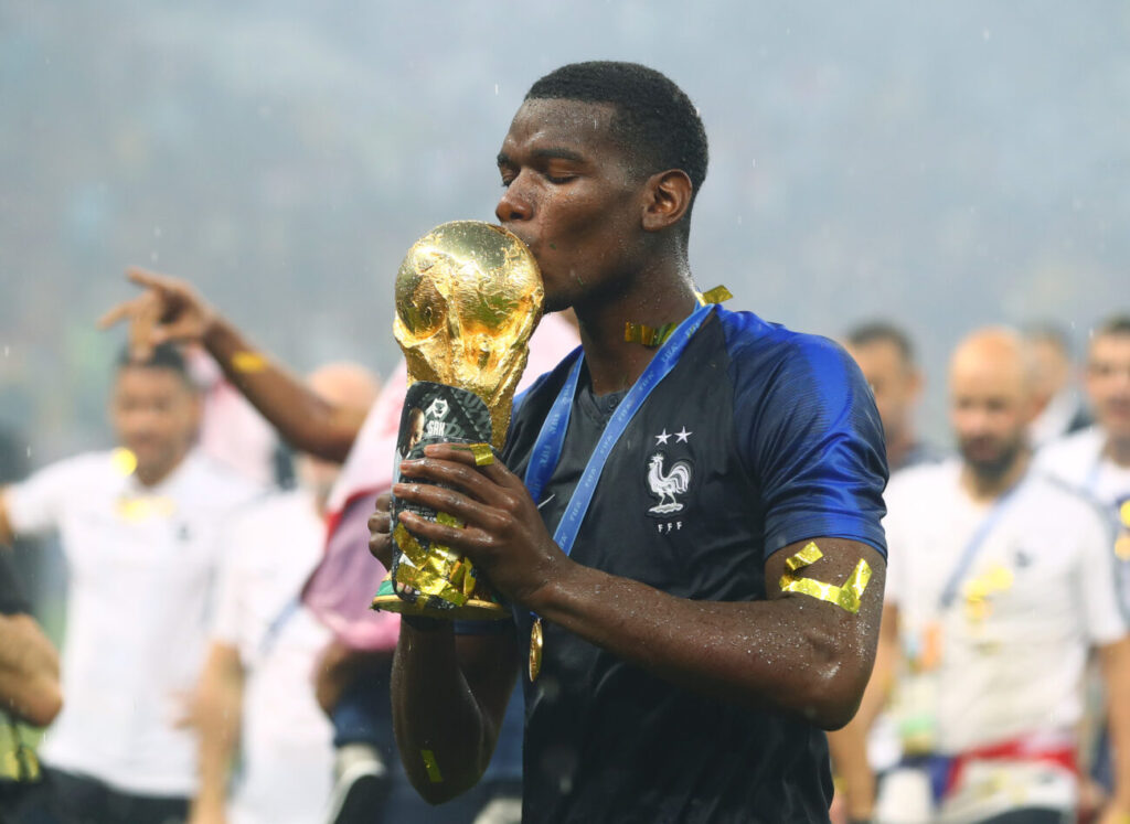 Mandatory Credit: Photo by Kieran Mcmanus/BPI/REX (9762196fz)
Paul Pogba of France kisses the FIFA World Cup trophy while holding his shin pads that have an image of his late father on them
France v Croatia, Final, 2018 FIFA World Cup football match, Luzhniki Stadium, Moscow, Russia - 15 Jul 2018