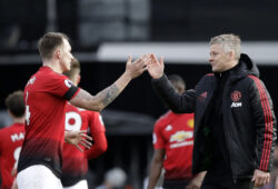 Manchester United caretaker head coach Ole Gunnar Solskjaer, right, and Manchester United's Phil Jones celebrate at the end of the English Premier League soccer match between Fulham and Manchester United at Craven Cottage stadium in London, Saturday, Feb. 9, 2019. (AP Photo/Matt Dunham)
