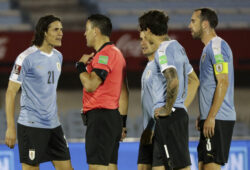 Uruguay's Edinson Cavani, left, complains to referee Roberto Tobar, of Chile, after he received the red card during a qualifying soccer match for the FIFA World Cup Qatar 2022 against Brazil at the Centenario stadium In Montevideo, Uruguay, Tuesday, Nov. 17, 2020. (Raul Martinez/Pool via AP)  XAP142